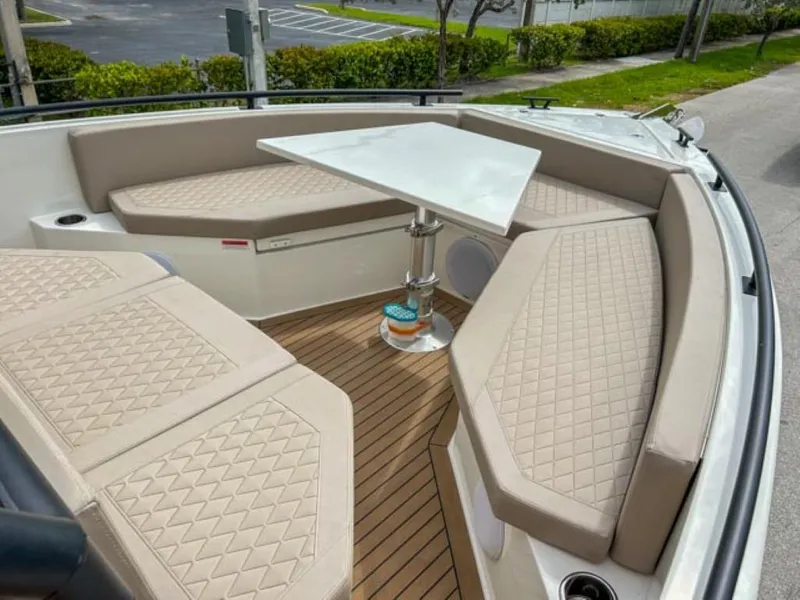 Slide: The Image of 2024 De Antonio Yachts D28 Xplorer interior with beige seating and a central table. - 6
