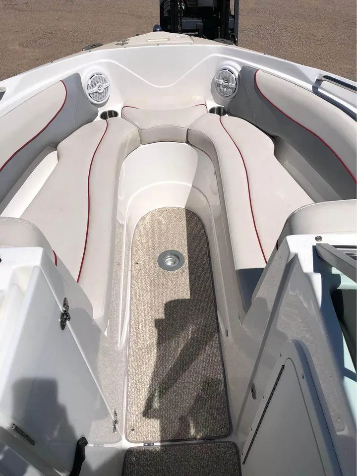 Slide: The Image of 2013 Rinker 246 Captiva Bowrider interior with cushioned seating and carpeted floor. - 2