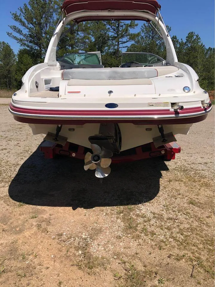 Slide: The Image of 2013 Rinker 246 Captiva Bowrider boat, rear view, parked on a trailer, outdoors. - 8