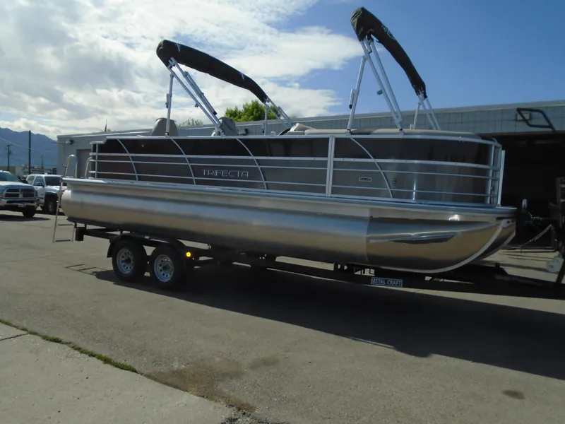 Slide: The Image of 2023 Trifecta 24TRFC LE 2.75 pontoon boat on a trailer. - 3