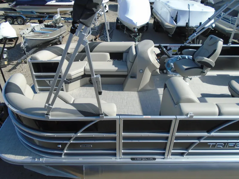 Slide: The Image of 2023 Trifecta 24TRFC LE 2.75 pontoon boat with beige seating and helm station. - 4