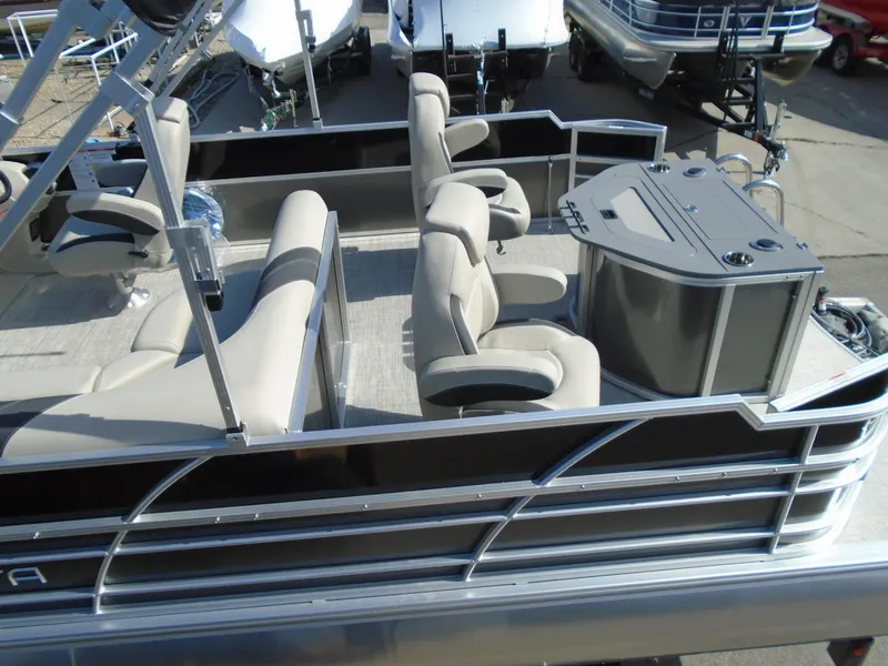 Slide: The Image of 2023 Trifecta 24TRFC LE 2.75 pontoon boat with beige seating and a sleek design. - 5