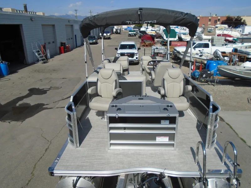 Slide: The Image of 2023 Trifecta 24TRFC LE 2.75 pontoon boat with seating and canopy in a marina. - 6
