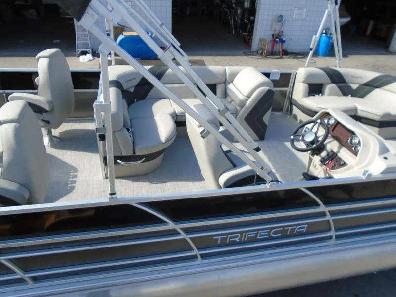 Slide: The Image of 2023 Trifecta 24TRFC LE 2.75 pontoon boat with spacious seating and modern design. - 7