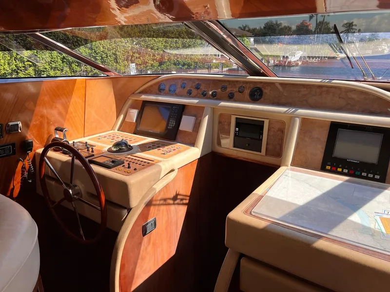Slide: The Image of Maiora 20 yacht helm station, 2001 model, featuring wooden dashboard and modern navigation equipment. - 12