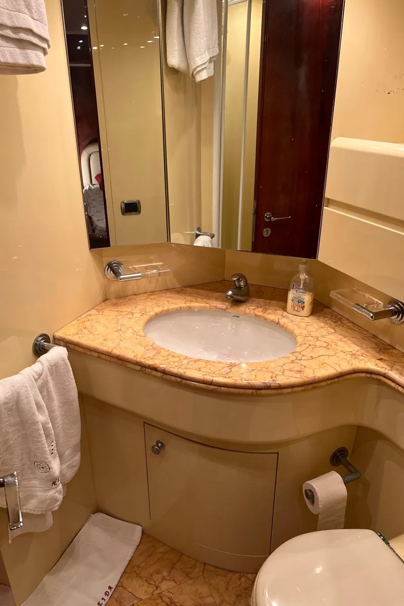 Slide: The Image of Luxurious bathroom in a 2001 Maiora 20 yacht with marble countertop and modern fixtures. - 15
