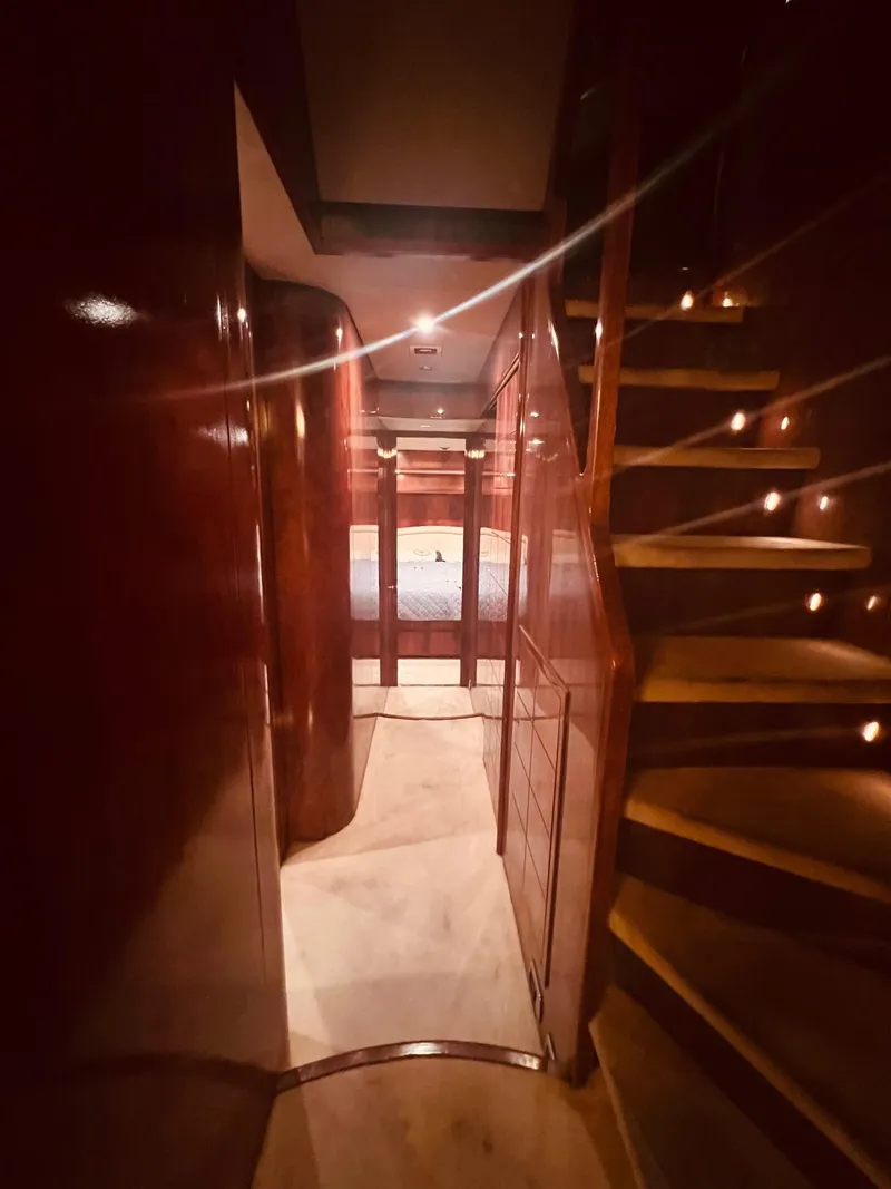 Slide: The Image of Interior of 2001 Maiora 20 yacht with wooden stairs and cozy lighting. - 16