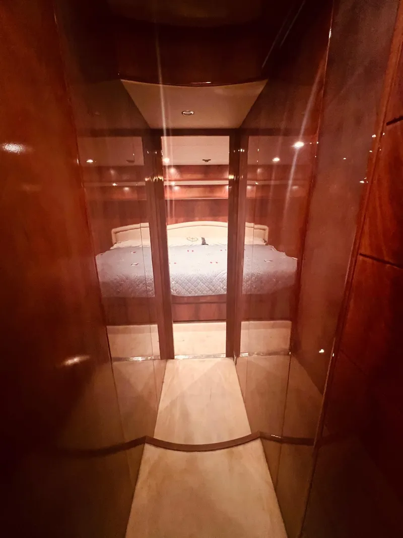 Slide: The Image of Luxurious bedroom interior of 2001 Maiora 20 yacht with wooden finishes. - 18