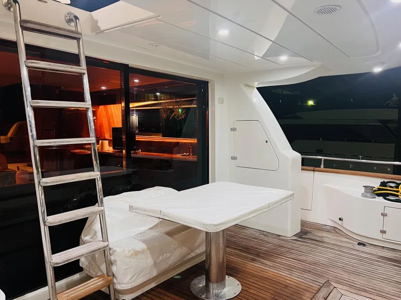 Slide: The Image of Maiora 20 yacht 2001 model, interior view with table, ladder, and wooden deck. - 2