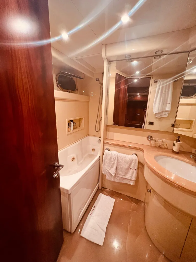 Slide: The Image of Luxurious bathroom in a 2001 Maiora 20 yacht with modern fixtures and elegant design. - 22