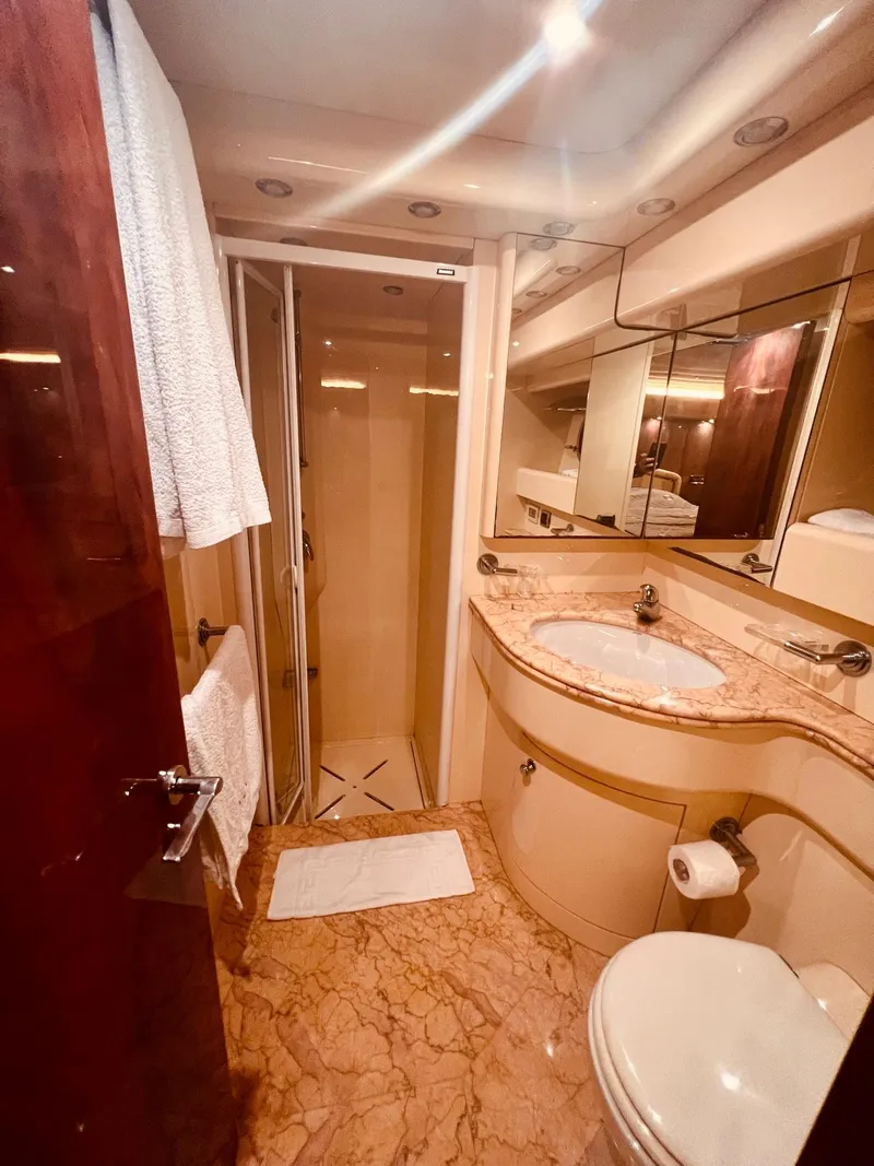 Slide: The Image of Luxurious bathroom in a 2001 Maiora 20 yacht with marble countertops and shower. - 25