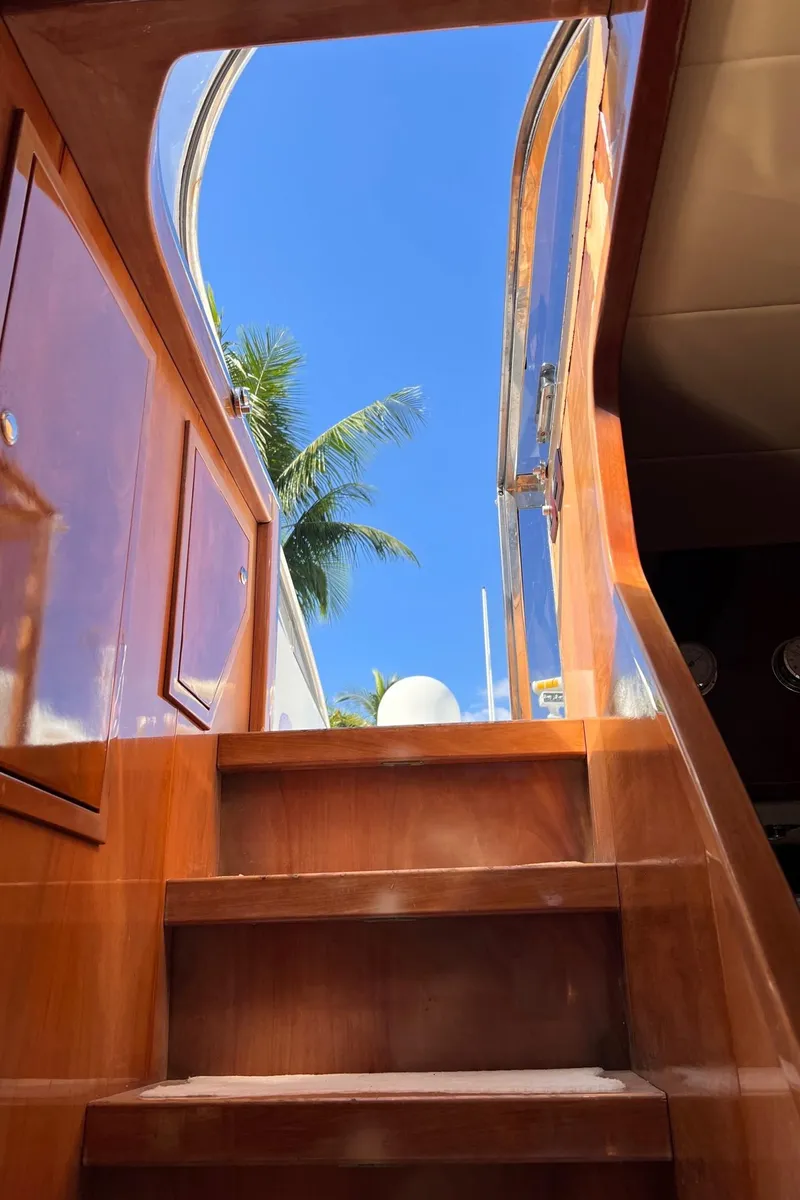 Slide: The Image of Staircase leading to the deck of a 2001 Maiora 20 yacht under a clear blue sky. - 6