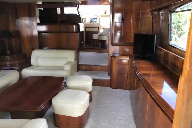 Slide: The Image of Luxurious interior of 2001 Maiora 20 yacht with wooden finishes and cream leather seating. - 7