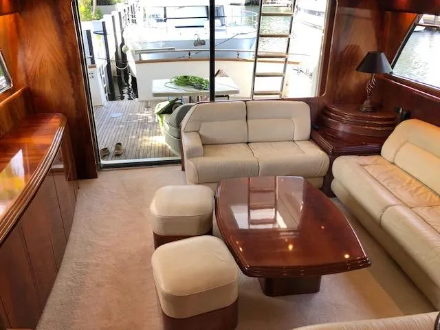 Slide: The Image of Luxurious interior of 2001 Maiora 20 yacht with plush seating and wooden accents. - 9