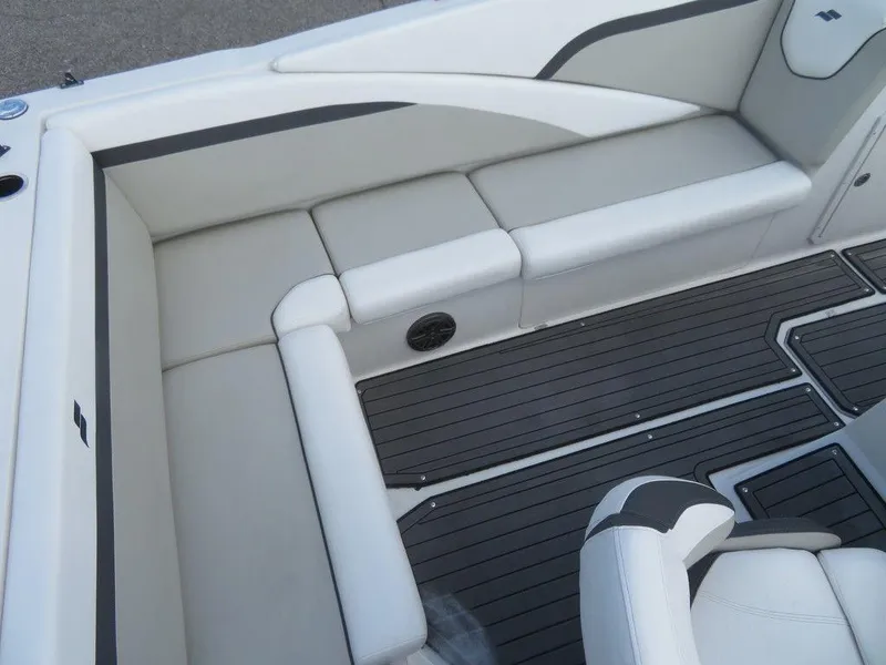 Slide: The Image of 2022 Starcraft 231 OB boat interior with white cushioned seating and black flooring. - 13