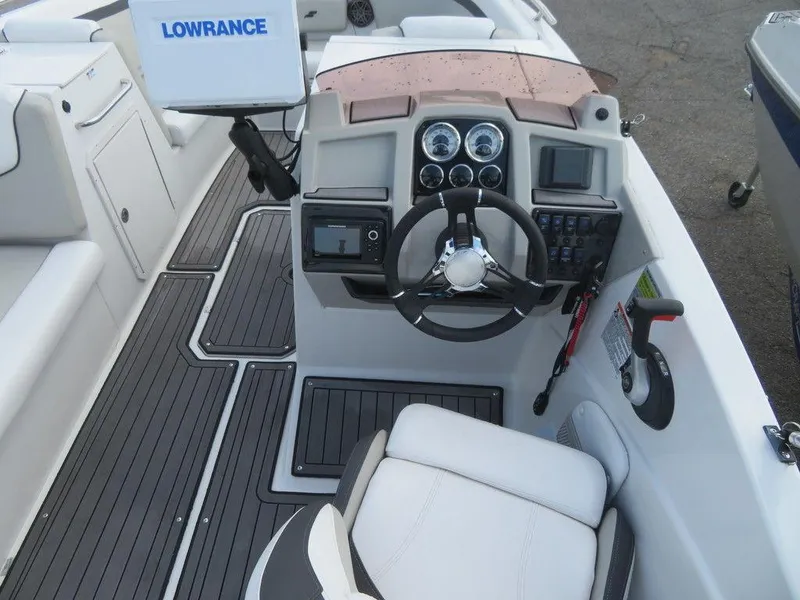 Slide: The Image of 2022 Starcraft 231 OB boat cockpit with steering wheel and Lowrance navigation system. - 9
