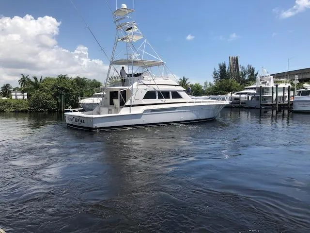 Slide: The Image of 1997 Bertram Convertible yacht on a sunny day in a marina. - 1