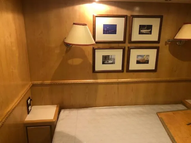 Slide: The Image of Interior cabin of a 1997 Bertram Convertible yacht with framed pictures and wall lamps. - 18
