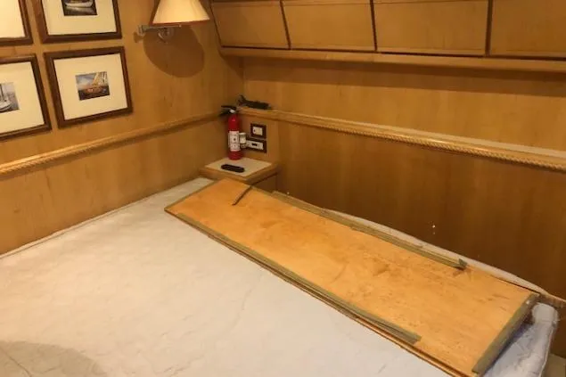 Slide: The Image of Interior cabin of a 1997 Bertram Convertible yacht with wooden paneling and framed pictures. - 19