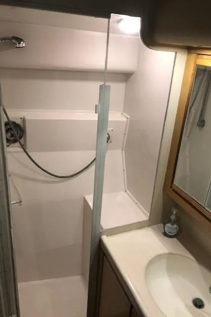 Slide: The Image of 1997 Bertram Convertible bathroom with shower, sink, and mirror. - 20