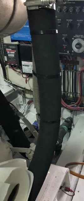 Slide: The Image of Engine room of a 1997 Bertram Convertible boat with visible wiring and hoses. - 22