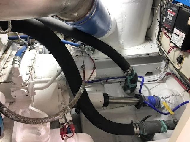 Slide: The Image of Engine room of a 1997 Bertram Convertible boat with hoses and mechanical components. - 23