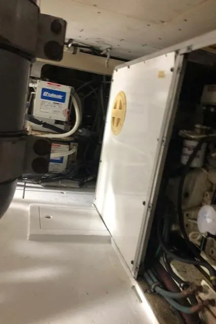 Slide: The Image of Engine room of a 1997 Bertram Convertible boat with battery and machinery. - 25