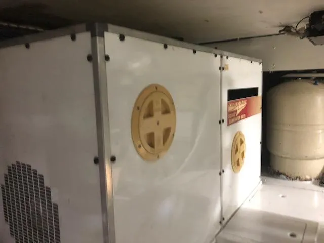 Slide: The Image of 1997 Bertram Convertible engine compartment with generator and equipment. - 34