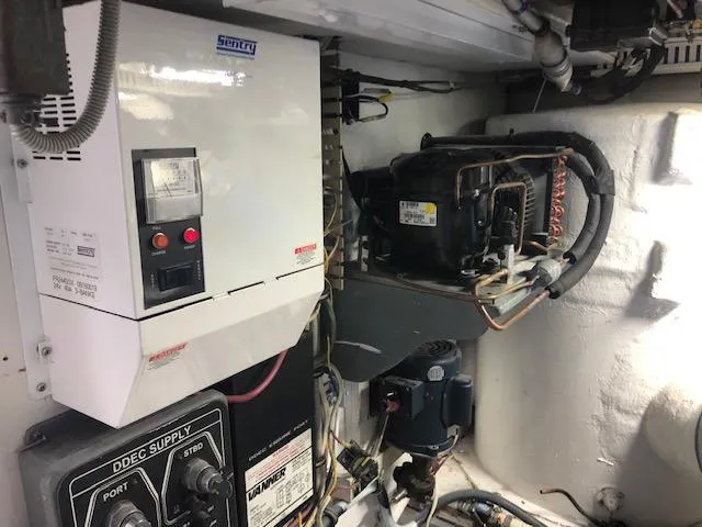 Slide: The Image of 1997 Bertram Convertible engine room with electrical and mechanical components. - 36