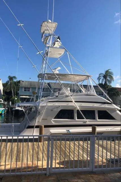 Slide: The Image of 1997 Bertram Convertible yacht docked at a marina on a sunny day. - 40