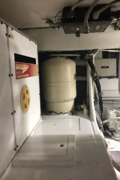 Slide: The Image of 1997 Bertram Convertible engine room with equipment and machinery. - 41