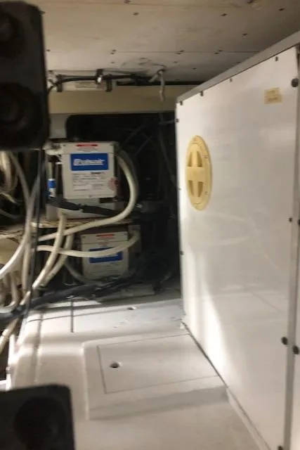 Slide: The Image of Engine room of a 1997 Bertram Convertible boat with electrical systems. - 42