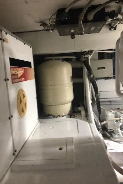 Slide: The Image of Engine room of a 1997 Bertram Convertible boat with machinery and equipment. - 43