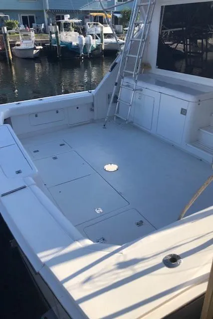 Slide: The Image of 1997 Bertram Convertible boat deck at a marina. - 46