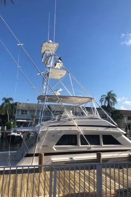 Slide: The Image of 1997 Bertram Convertible yacht docked at a marina. - 48