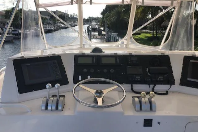 Slide: The Image of 1997 Bertram Convertible boat helm with navigation instruments and controls. - 49