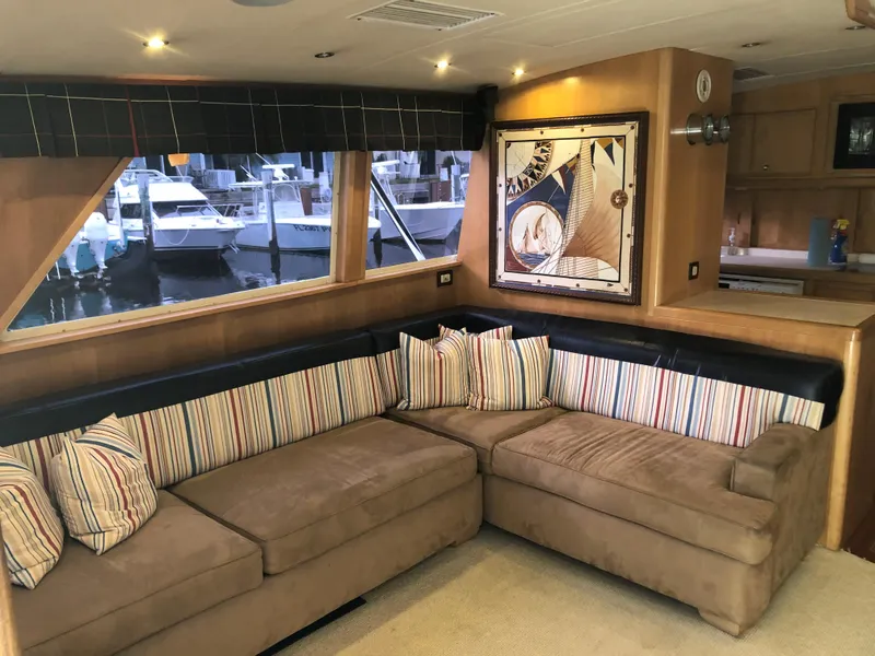 Slide: The Image of Luxurious interior of a 1997 Bertram Convertible yacht with a cozy sectional sofa. - 6