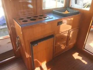 Slide: The Image of 1992 Crosby Tug interior with wooden cabinetry and mini fridge. - 11