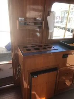 Slide: The Image of 1992 Crosby Tug interior with wooden cabinetry and countertop. - 12
