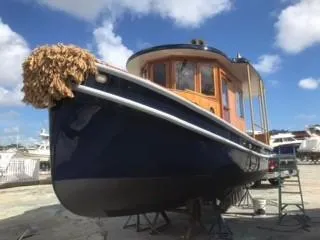 Slide: The Image of 1992 Crosby Tug boat on dry dock under a clear blue sky. - 15