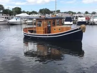 Slide: The Image of 1992 Crosby Tug boat docked in a marina with other boats. - 3