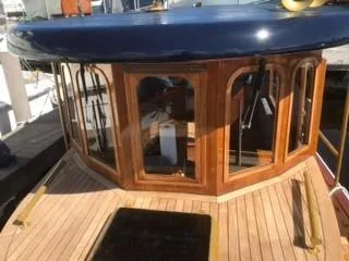 Slide: The Image of 1992 Crosby Tug boat with wooden cabin and blue roof docked at marina. - 7