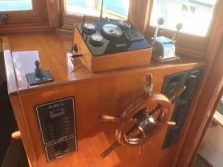 Slide: The Image of 1992 Crosby Tug boat helm with wooden wheel and control panel. - 9