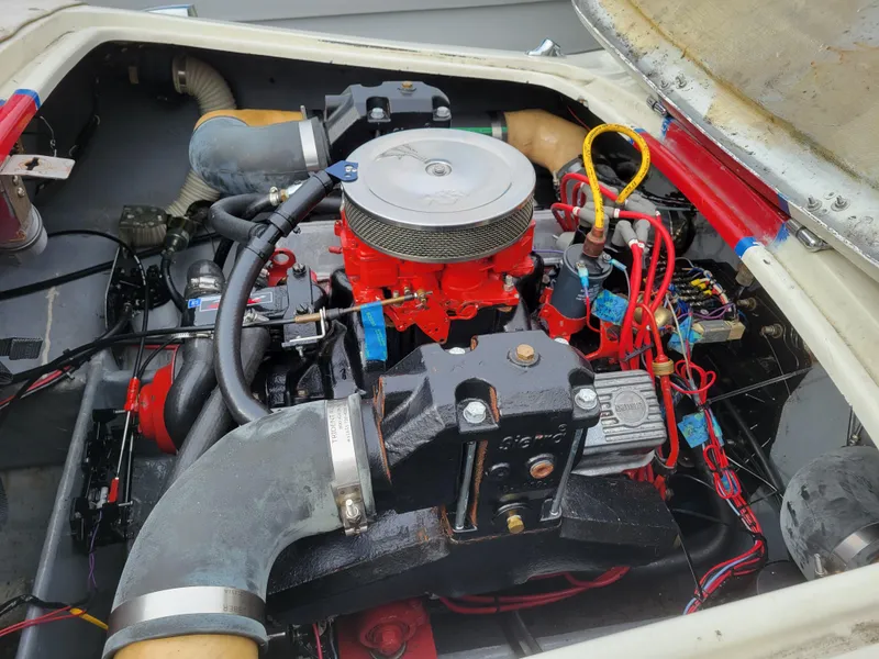 Slide: The Image of Engine of a 1973 Donzi X18 boat, featuring red and black components with visible wiring. - 13