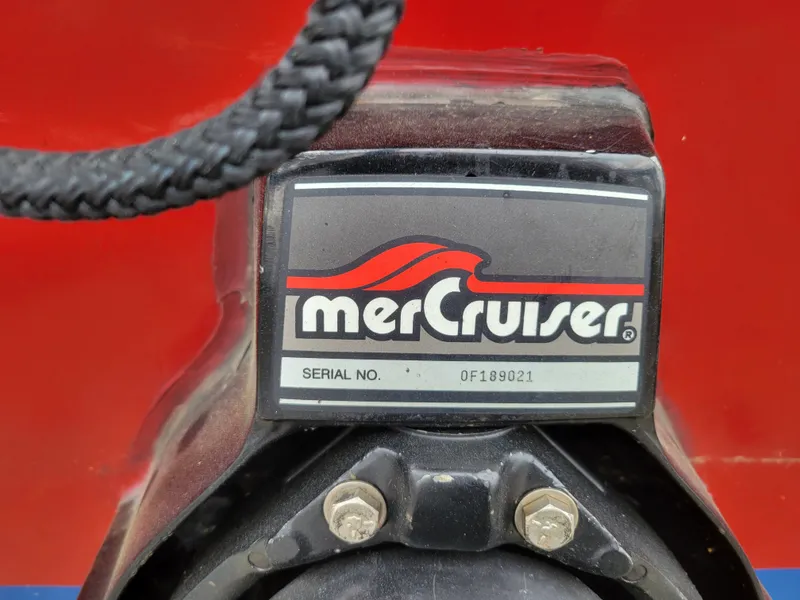 Slide: The Image of MerCruiser engine part on 1973 Donzi X18 boat, serial number visible. - 18