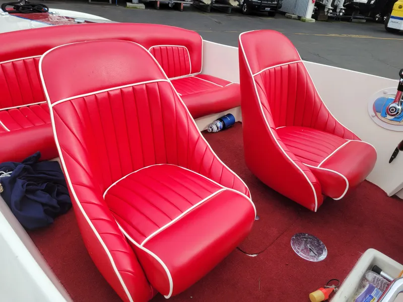 Slide: The Image of 1973 Donzi X18 boat interior with vibrant red and white seats. - 3