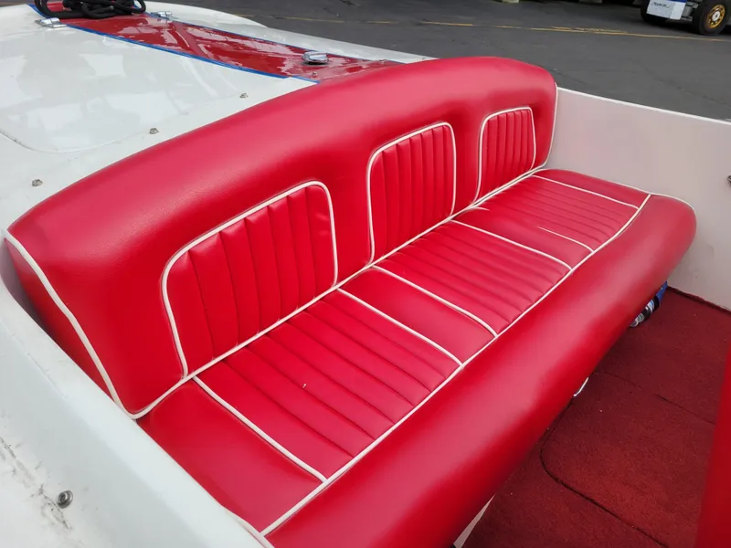 Slide: The Image of Red and white upholstered seating in a 1973 Donzi X18 boat. - 4