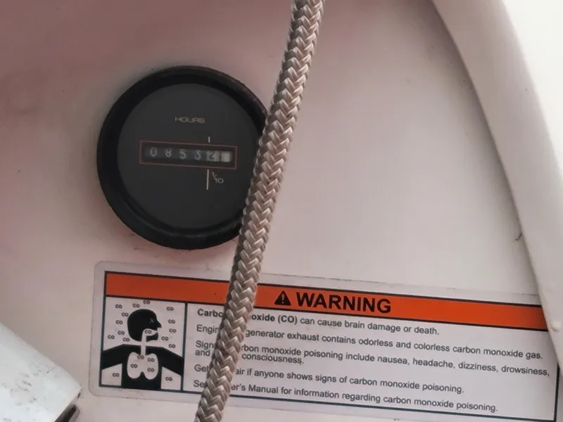 Slide: The Image of Hour meter and carbon monoxide warning on 1973 Donzi X18 boat dashboard. - 9