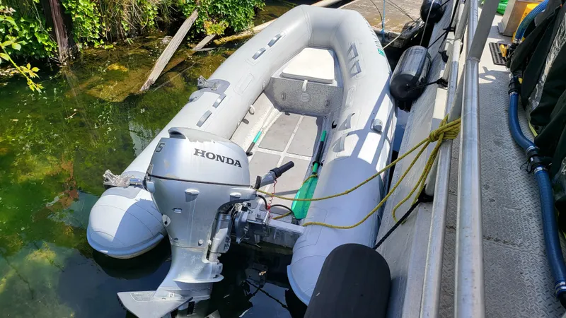 Slide: The Image of 2014 AB Inflatables Lamina 10 with Honda outboard motor docked. - 3