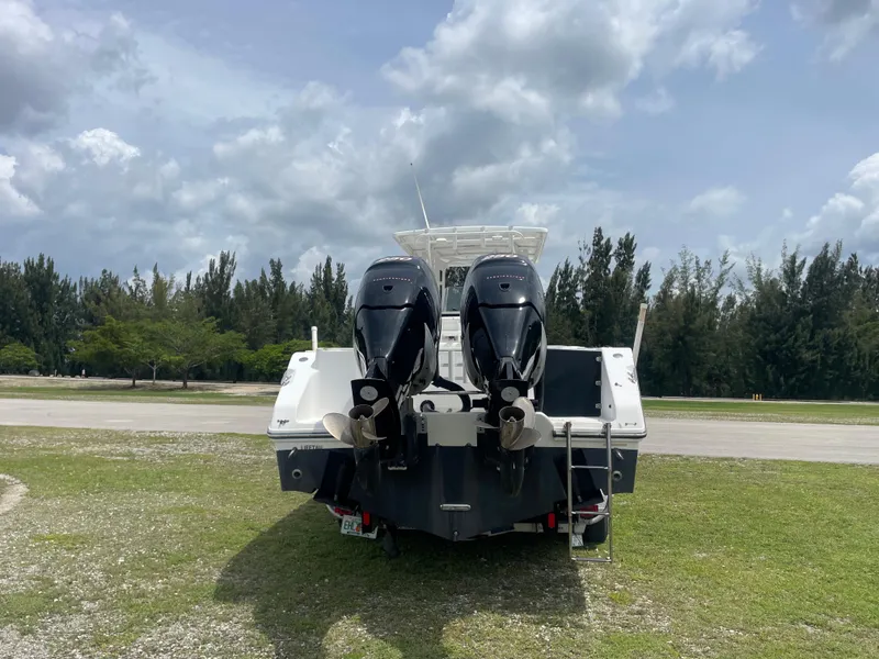 Slide: The Image of 2006 Angler 2900CC boat with twin outboard motors on grassy area. - 11